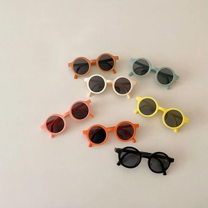 Detailed flat lay of children's round matte sunglasses in seven pastel candy colors