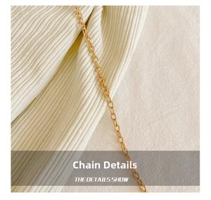 Macro shot of polished gold O-chain metal strap with elegant diamond-quilted texture