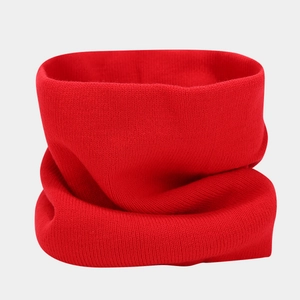 Close-up of red knit infinity scarf showing soft thick fabric and high-quality stitching