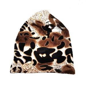 Detail view of the thick plush leopard print fabric on a winter warm beanie hat