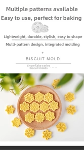 Various snowflake-shaped cookies made with the multi-pattern biscuit mold collection