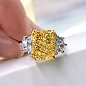 Macro shot of Radiant-cut yellow stone and trapezoid side stones in silver band