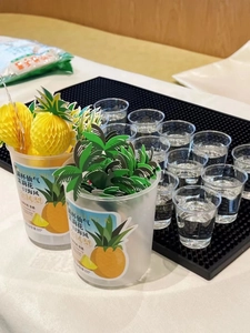 Detail of 3D pineapple decorative cocktail picks in a clear container for party use
