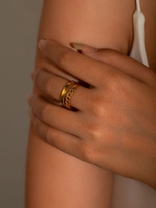 Detail of a dual-layer gold titanium steel ring featuring a smooth band and chain texture