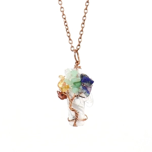 Close-up of tree of life pendant with colorful natural stones and copper wire