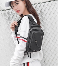 Detail view of black waist bag showing adjustable strap buckle and durable material