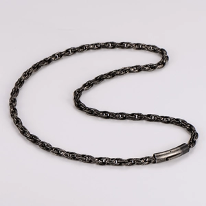 Close-up of vintage twisted chain necklace with cylindrical barrel clasp detail