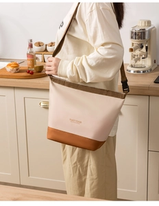 Detail of insulated lunch bag with adjustable shoulder strap and leather-like bottom