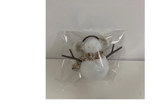 Close-up of a glowing plush snowman ornament with a brown plaid scarf in packaging