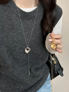 Detail of irregular molten lava pendant necklace on a model showing adjustable length
