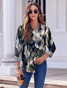 Detail of abstract ink print blouse showing button-down collar and long sleeve texture