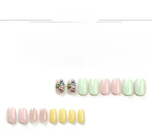 Detailed view of pastel macaron press-on nails with 3D bunny and strawberry accents
