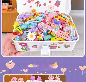 Detail of colorful resin flower and rainbow hair clips inside a cute storage box