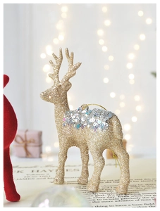 Close-up of a golden glitter reindeer ornament with silver sequins for Christmas tree decor