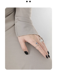 Close-up of S925 sterling silver ring with blue zircon inlay on a model hand