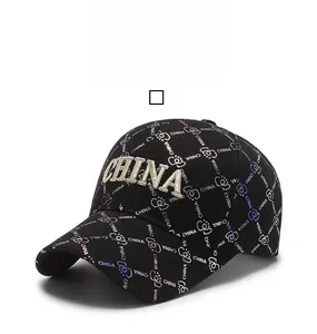 Close-up of golden 3D CHINA embroidery and colorful patterns on a black baseball cap