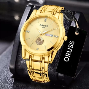 Macro view of gold quartz watch featuring a sailboat relief dial and rhinestone markers