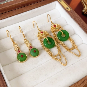 Detail of gold-plated lute and lotus earrings with green jade inlays and long tassels