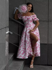 Detail of floral off-shoulder dress with puff sleeves and elegant high slit side profile