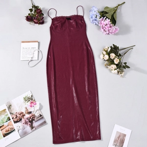 Detail of burgundy snakeskin texture on a strapless long dress with stylish props