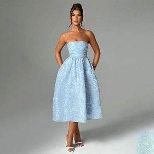Detailed view of blue strapless A-line dress with floral jacquard texture and waist cinching