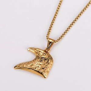 Detailed close-up of a golden eagle head pendant with intricate metallic textures