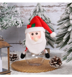 Detail of Santa Claus candy jar with transparent base on a festive snowy background