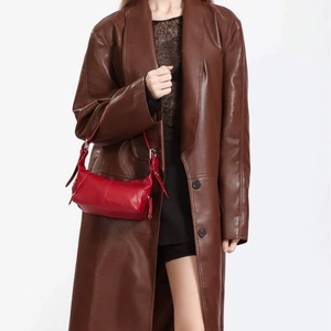 Chic red leather underarm bag with adjustable strap worn by a model in a leather coat