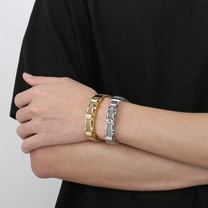 Men's industrial chain bracelets in gold and silver finish worn on wrist with metal links