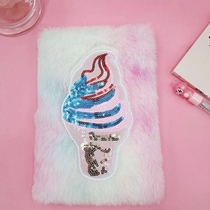 Detailed close-up of plush notebook cover with colorful sequin ice cream patch