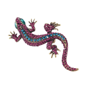 Vintage lizard brooch with pink and blue rhinestones on a gold-tone metal base