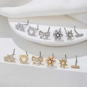 Set of 12 stainless steel nose studs with butterfly and crown designs in gold and silver