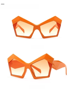 Detail view of bold orange geometric oversized sunglasses with yellow gradient lenses