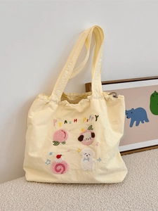 Pale yellow canvas tote bag with cute puppy towel embroidery and drawstring closure