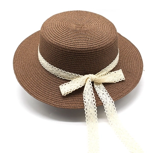 Detail of the woven texture and cream lace bow on this dark brown boater sun hat