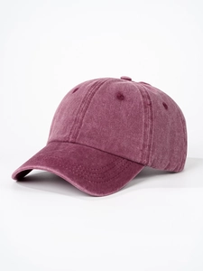 Close-up of washed cotton baseball cap in burgundy showing texture and stitching details
