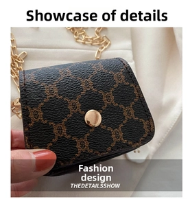 Detail of a mini monogram canvas bag with vintage gold buckle and fine chain strap