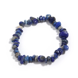 Macro shot of natural lapis lazuli stone beads with dark blue textures on elastic bracelet