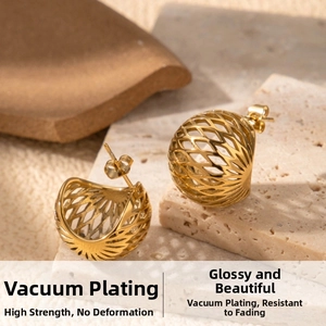 Macro shot of gold plated hollow geometric earrings with woven metal texture and high polish