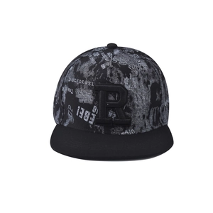 Close-up of 3D embroidered letter R on a black snapback cap with graffiti print