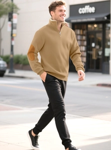 Detail of khaki quarter-zip sweatshirt with elbow patches and black jogger pants