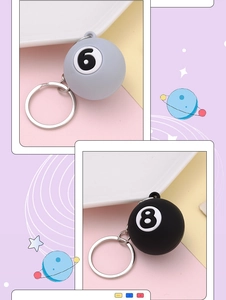 Close-up of billiard ball keychains in grey 6 and black 8 styles with metal rings