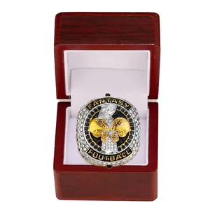 Silver Fantasy Football champion ring with gold helmet in a wooden jewelry box