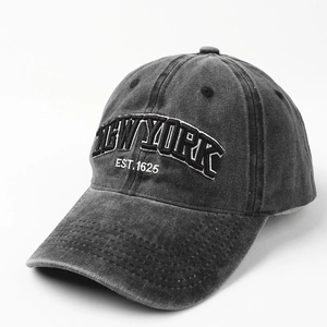 Macro detail of 3D New York embroidery on washed cotton canvas baseball cap surface
