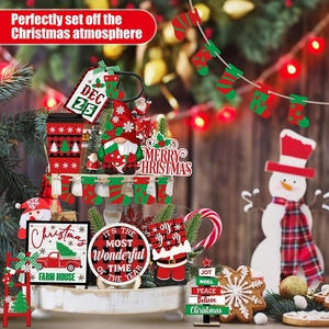 Macro detail of Christmas tiered tray wood signs with festive gnome and holiday motifs