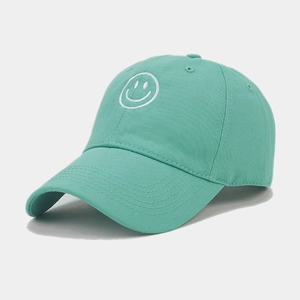 Close-up of mint green cotton baseball cap featuring a white smiley face embroidery