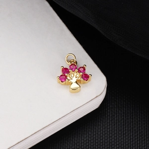 Macro shot of 18K gold-plated tree pendant with pink faceted stones for jewelry DIY