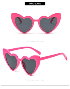 Detailed view of pink heart-shaped sunglasses with dark lenses from front and side angles