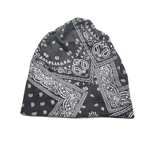 Detailaufnahme einer schwarzen Baumwollmütze mit weißem Paisley-Muster auf weißem Hintergrund