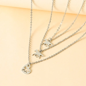 Detail of silver stainless steel heart necklace with horse pendants and layered chains